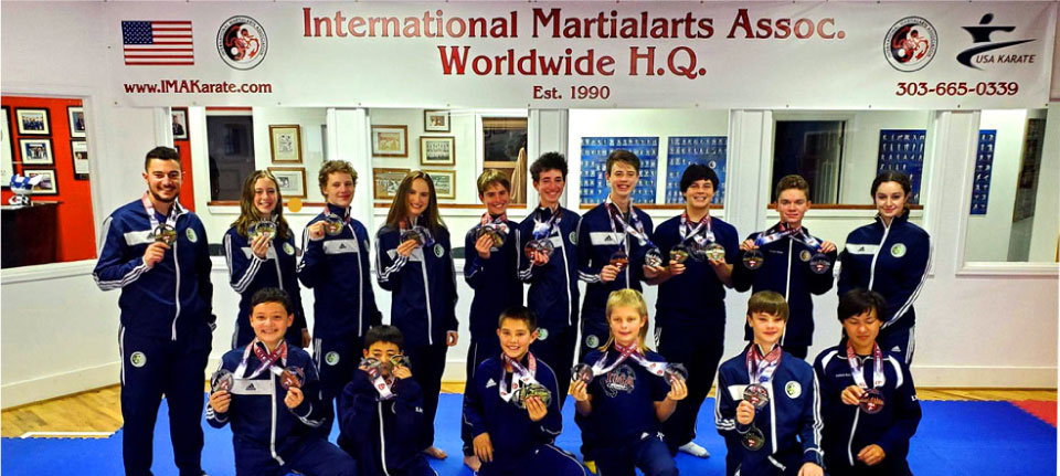 group photo of students holding up medals