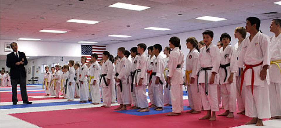 young studens in line watching instructor